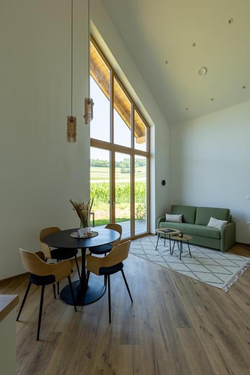 a living room with a table and chairs and a couch at Glamping resort Dolenjc in Novo Mesto