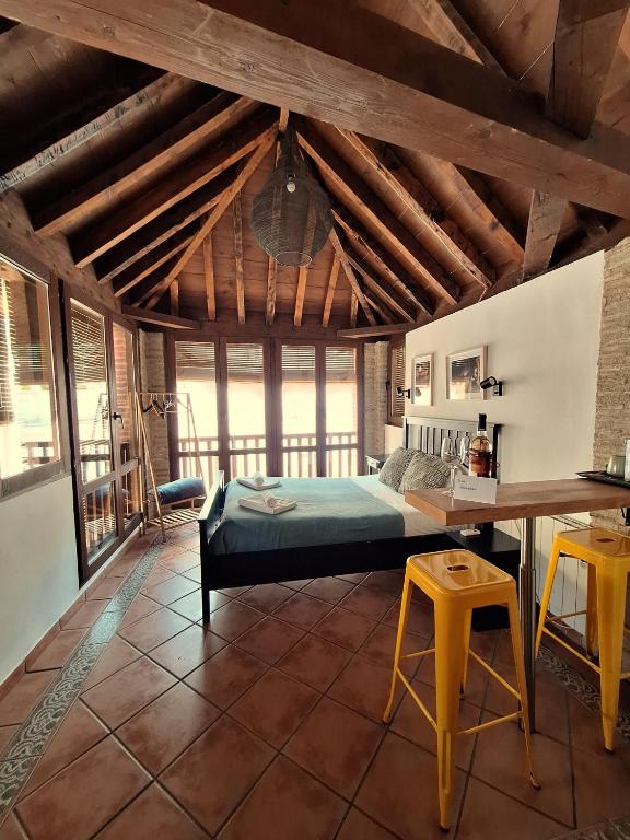 a bedroom with a bed and a desk in a room at Urban Suites Granada in Granada