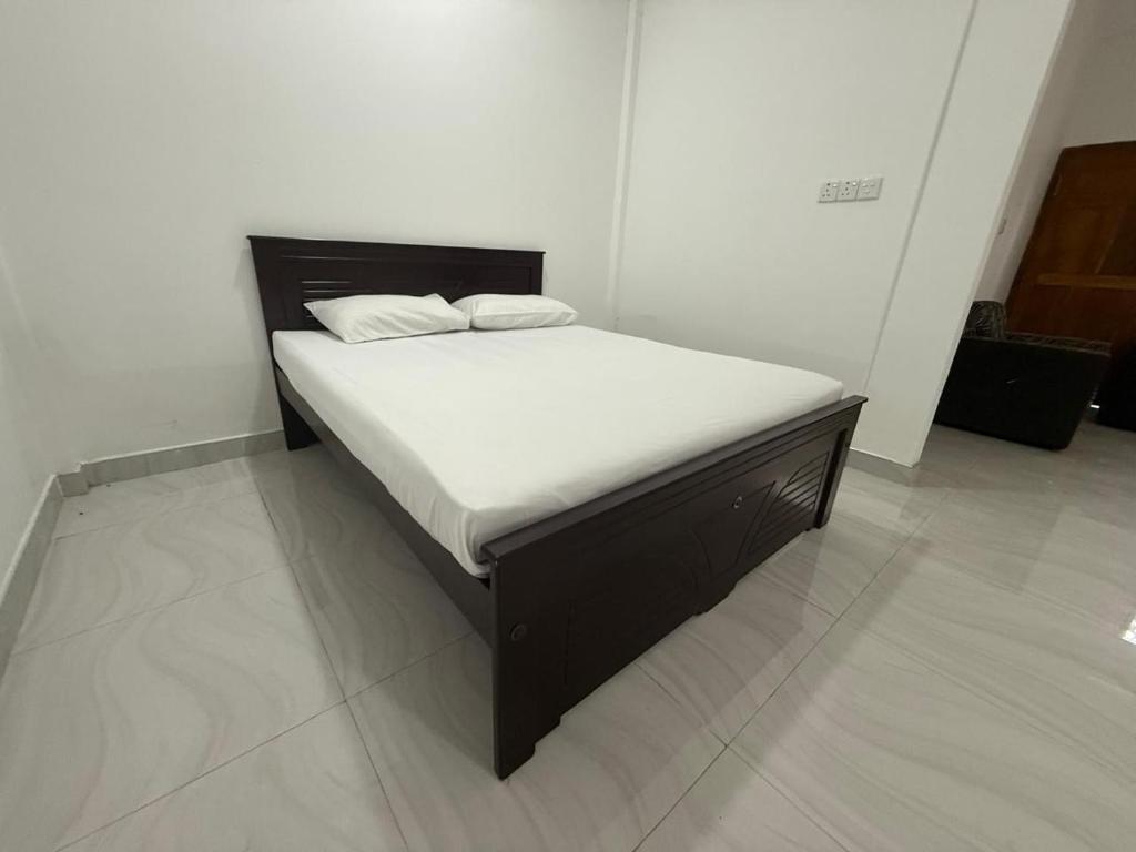 a bed in a room with a white mattress at Jaffna Gateway Hotel and Restaurant in Kanakarayankulam