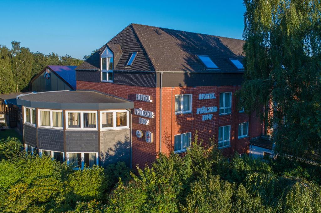 an aerial view of a brick building with a house at Hotel Pfälzer Hof GmbH in Braunschweig