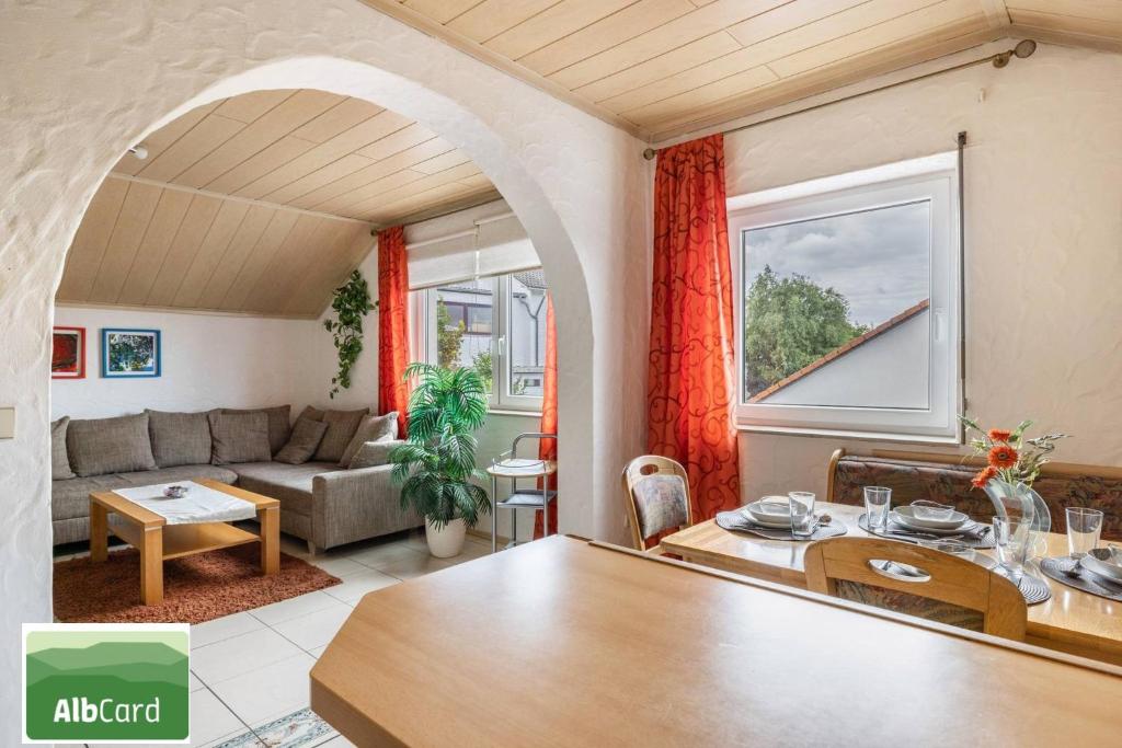 a living room with a couch and a table at Haus Fabio in Großengstingen