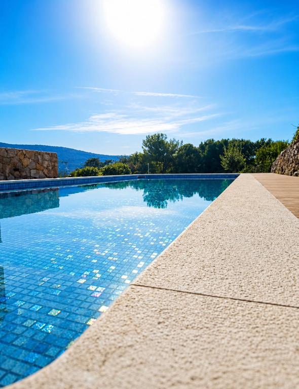 a swimming pool with a view of the mountains at Apartment Leni in Cres
