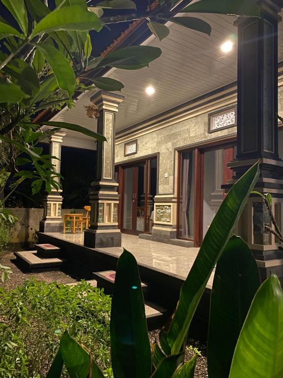a front porch of a house with plants at Adisamasta Guesthouse in Sidemen