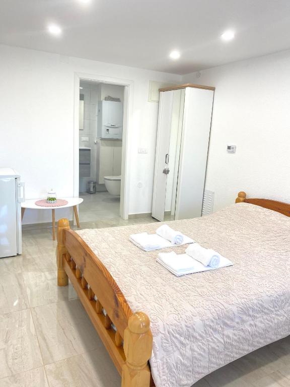 a bedroom with a bed with two towels on it at Dora Apartman in Tomislavgrad