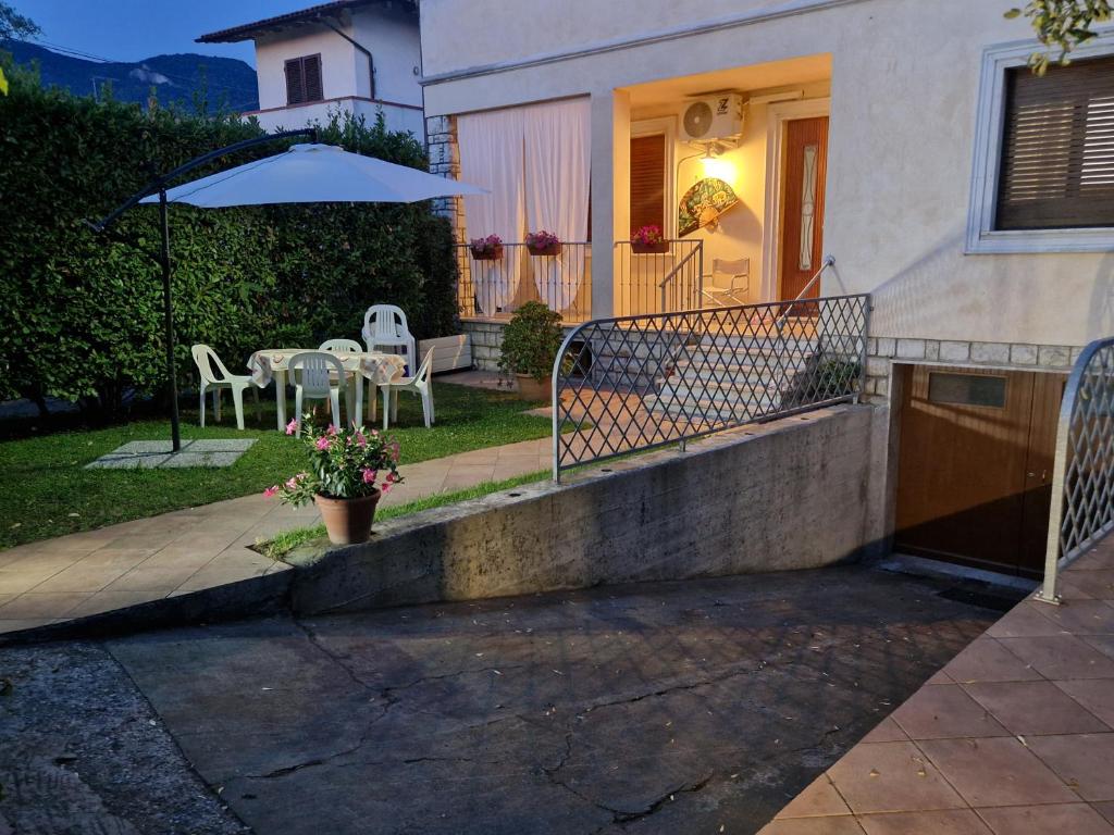 a house with a porch with a table and an umbrella at CasaMiria in Seravezza