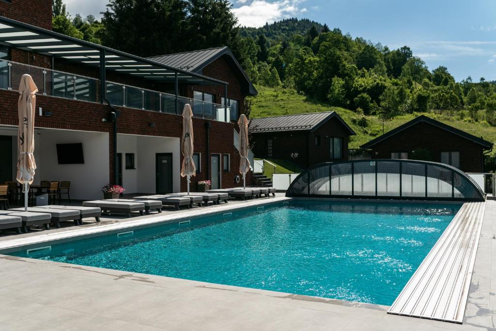 a swimming pool in front of a building at Brick House in Borşa