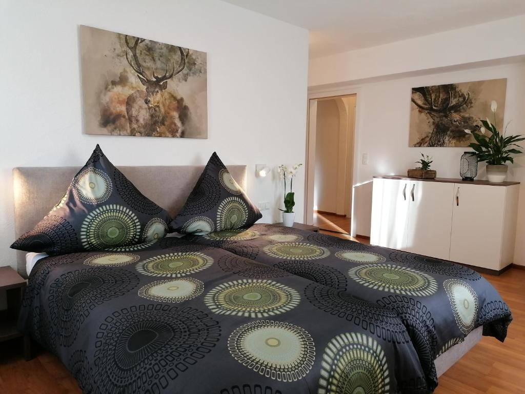 a bedroom with a large bed with pillows on it at Hölbinger Alm - Apartments in Anger