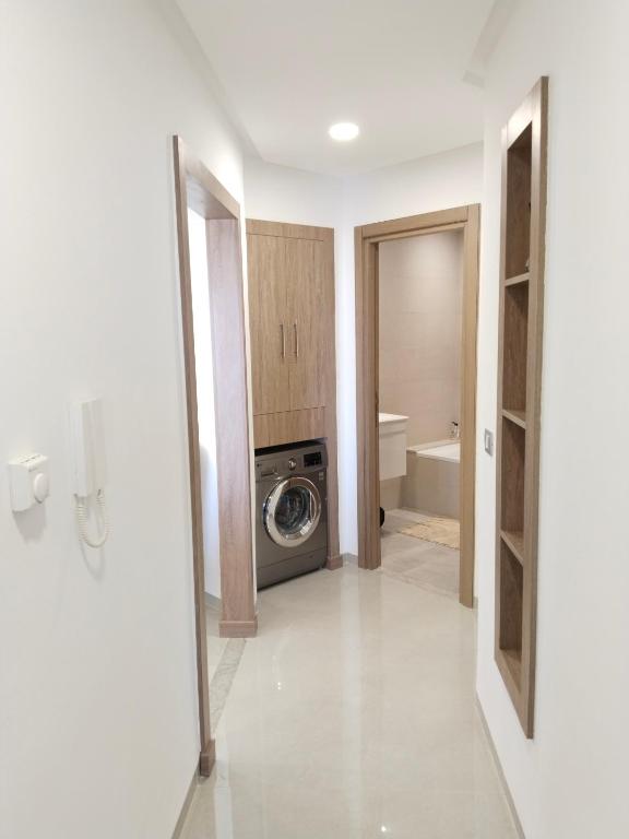 a bathroom with a washing machine in a room at Résidence Costa in Sousse