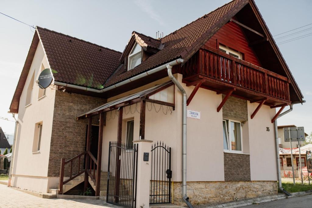 a small house with a wooden roof at Villa Rustica in Bešeňová