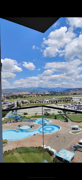 an overhead view of a water park with three pools at Modern Riverside Apartment in Sarajevo