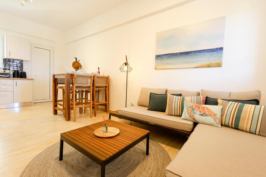 a living room with a couch and a table at Pachynammos Studios & Apartments in Kypseli