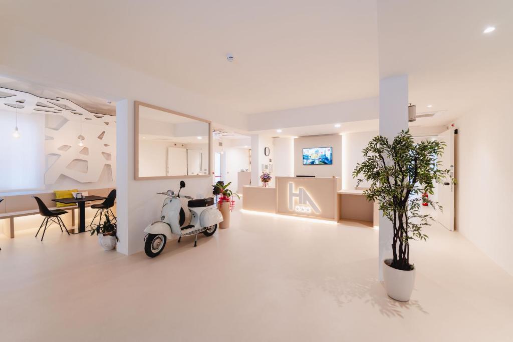 a white room with a scooter parked in it at Hotel Anny in Lido di Jesolo