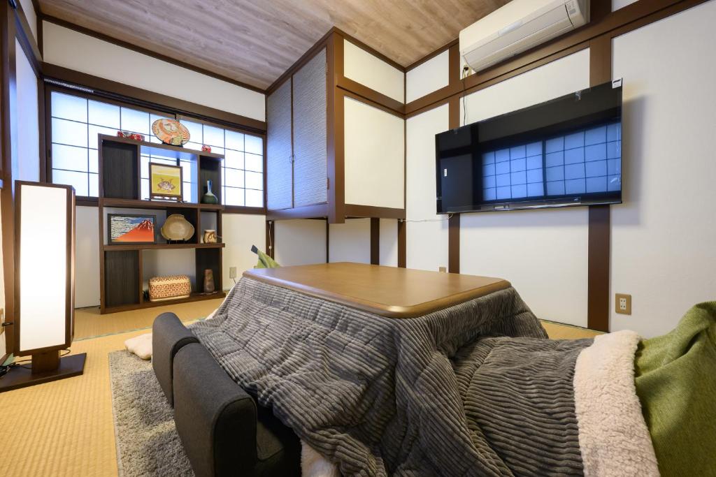 a living room with a couch and a table at soleggiato suminoe in Osaka