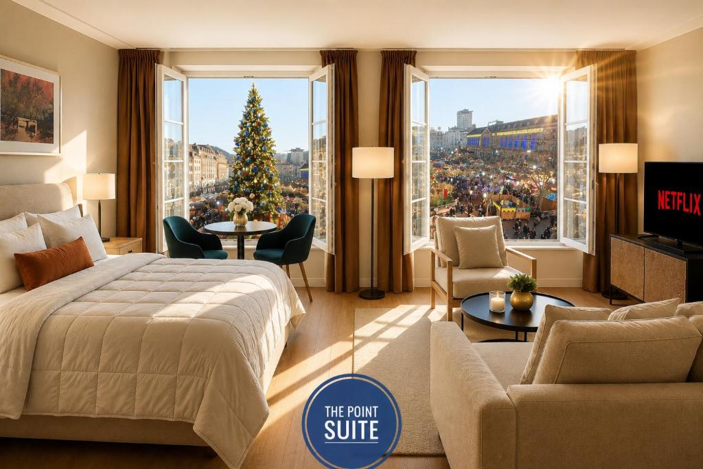 a hotel room with a large bed and a christmas tree at The POINT CITY-Center - Place KLEBER in Strasbourg