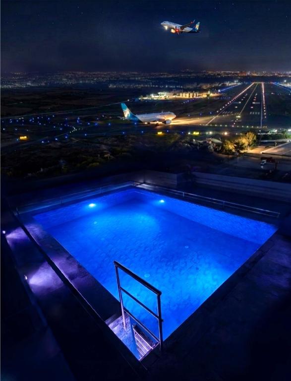 a swimming pool on top of a building at night at Best Eastern Apartments - With Balcony & Kitchen in Dhaka