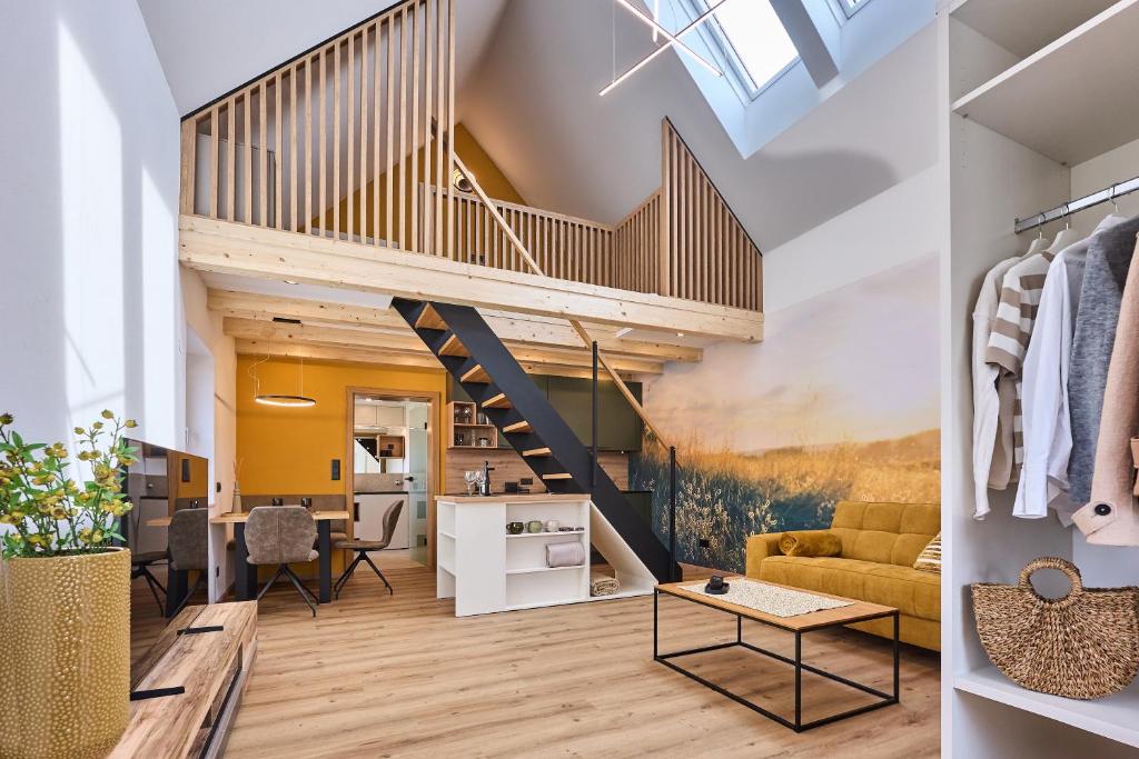a loft conversion with a staircase and a living room at Wiegehaus Retz in Retz