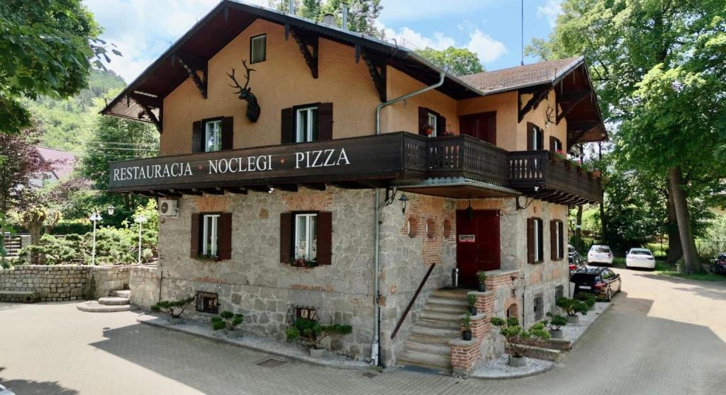 a building with a sign on the front of it at Willa Róża Karkonoszy in Jelenia Góra