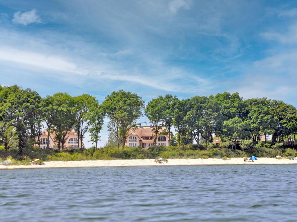 a group of houses on the shore of a beach at Reethus am Strand - Haushälfte 1 mit Kamin, Sauna in Lobbe