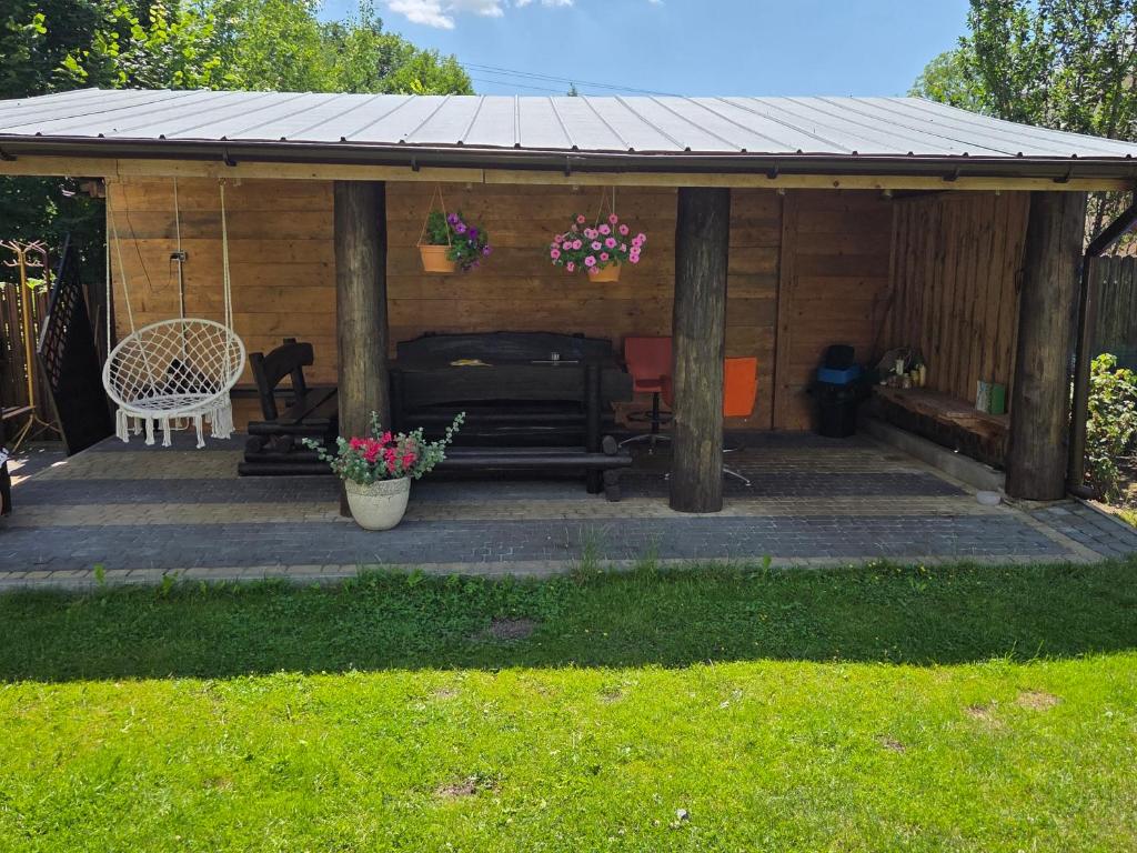 a wooden pavilion with a bench and a table at BECEJŁY de LUX in Becejły