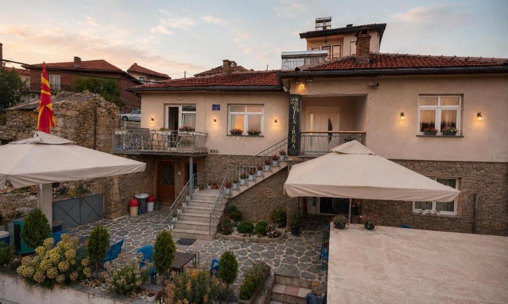 a house with two umbrellas in front of it at Villa Irena in Kruševo