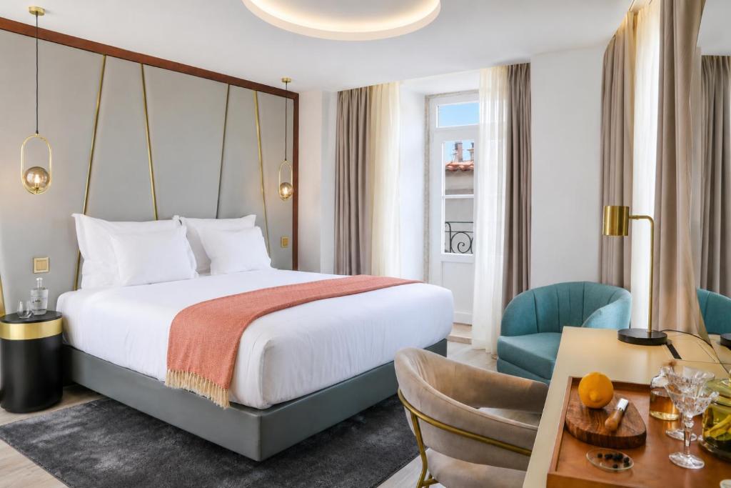 a hotel room with a bed and a desk at Vincci Alfama in Lisbon