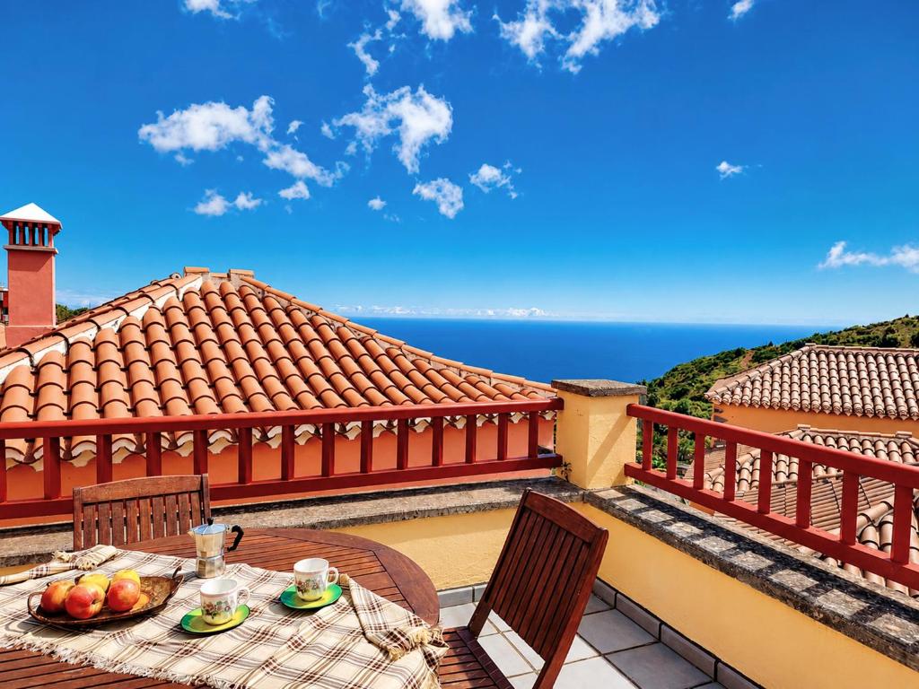 a table with a bowl of fruit on a balcony at Emiliana in Puntallana