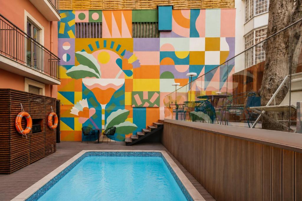 a mural on the side of a building with a pool at Vincci Liberdade in Lisbon