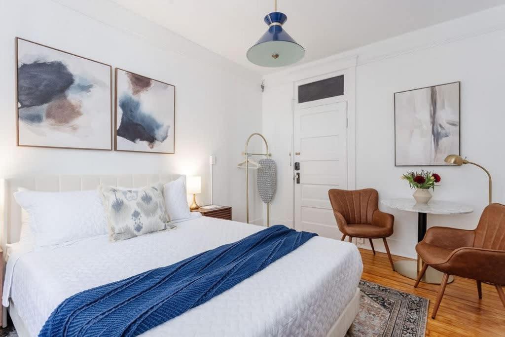 a bedroom with a bed and a table and chairs at Chic Studio Apartment on Oglethorpe Square in Savannah