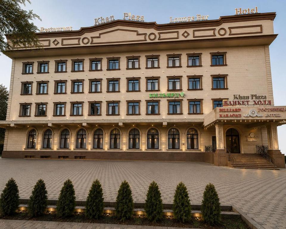 a large building with trees in front of it at Khan Plaza Hotel in Almaty
