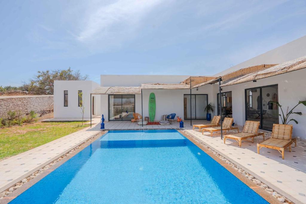 a villa with a swimming pool and a house at 3Moon Guesthouse in Aït Yassine