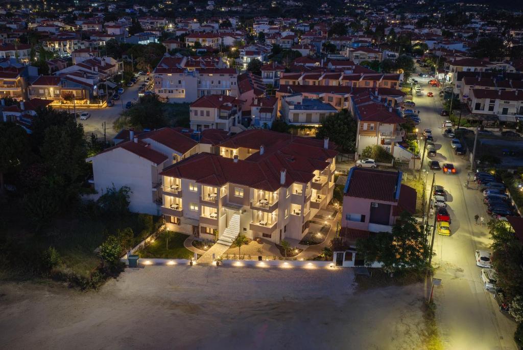 an aerial view of a city at night at AMARÉ suites in Nikiti