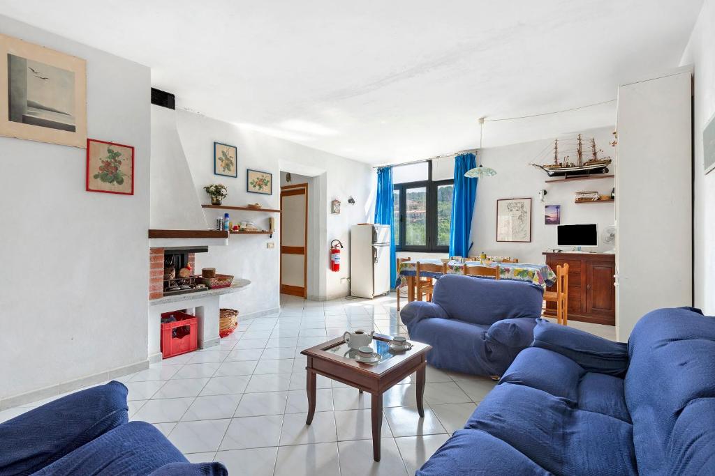 a living room with blue couches and a table at Casa Violina - Portoferraio in Portoferraio