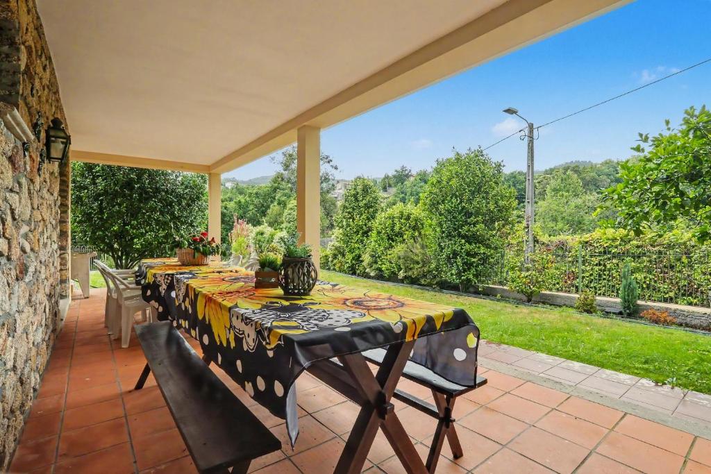 a patio with a table and chairs on a patio at Casa da Giesta in Roge