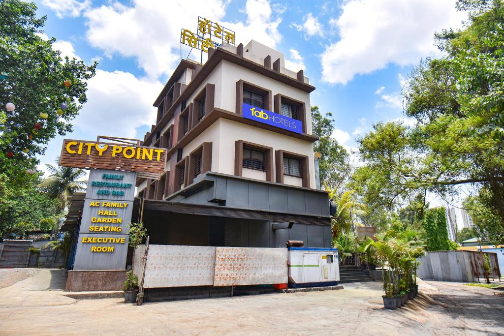 a building with a sign in front of it at FabHotel City Point Executive in Pune