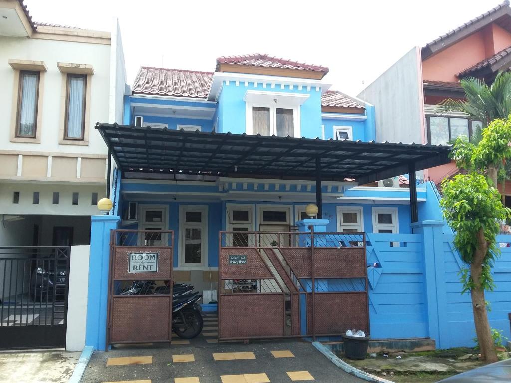 a blue house with a black roof at Homey House Serpong in Serpong