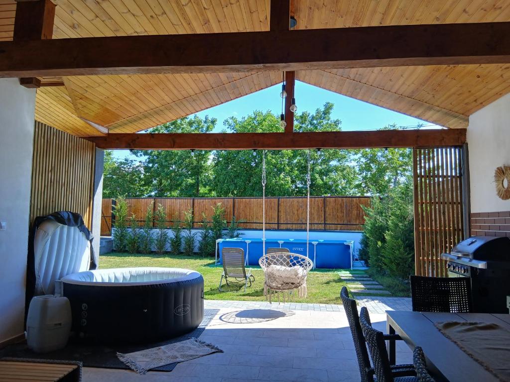 a screened in patio with a table and chairs at Popa Cabana in Sibiu