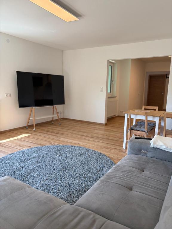 a living room with a bed and a flat screen tv at Modern Apartment 1 Graf - New! in Grafenwöhr