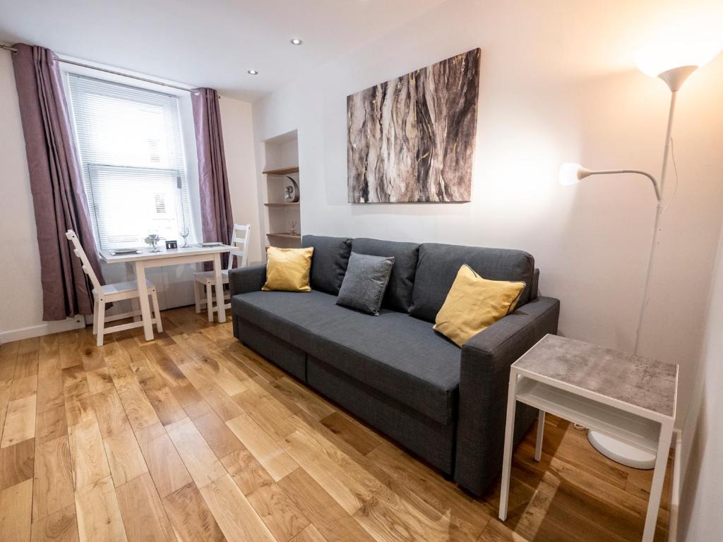 a living room with a couch and a table at 93 King Street in Broughty Ferry