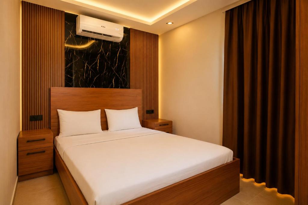 a bedroom with a white bed in a room at Palmiye Suite Hotel Bakirkoy City Center in Istanbul