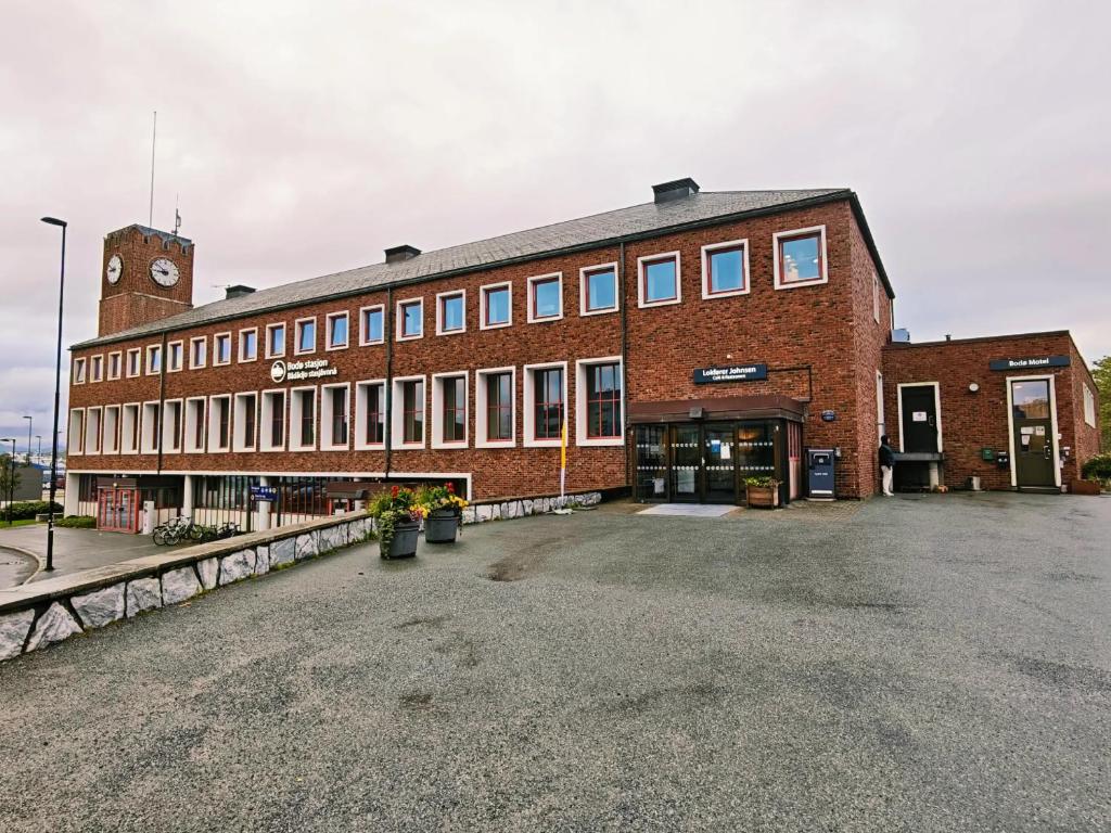 a large red brick building with a clock tower at Bodo Motel Norway in Bodø
