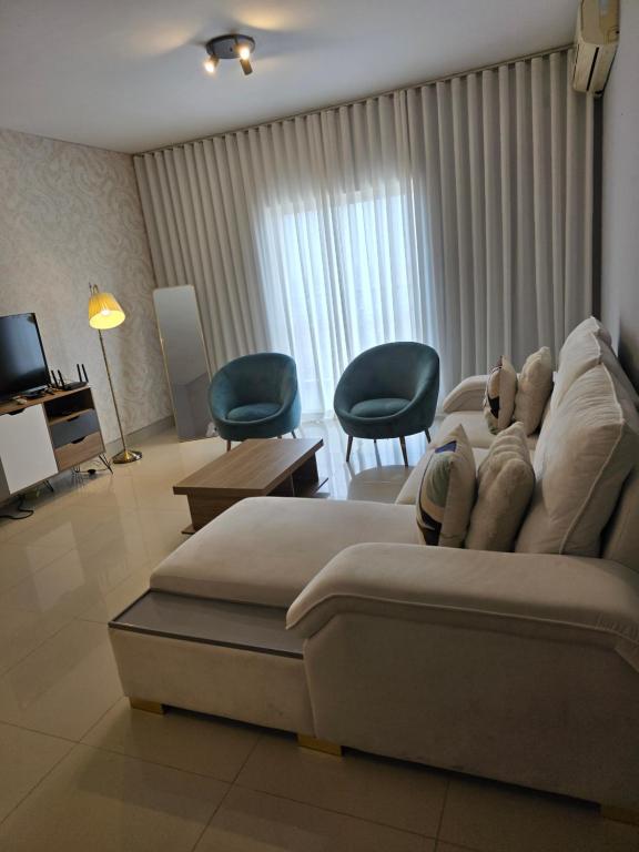 a living room with a couch and two chairs at C7 double up in Camama