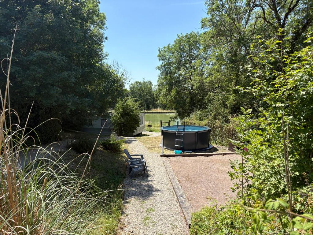 a picnic table and a bench in a garden at La Louée du canal in Braux