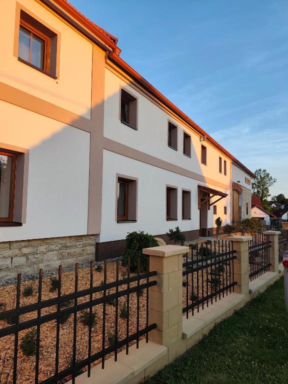a building with a fence in front of it at Statek u Juzů in Dolní Újezd