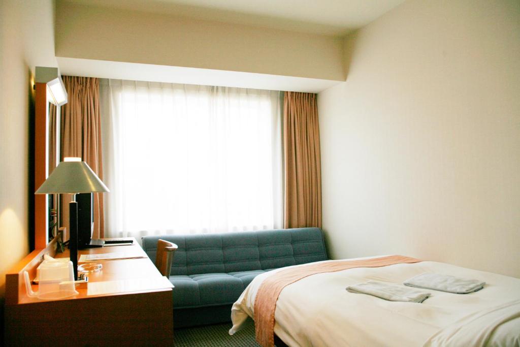 Postel nebo postele na pokoji v ubytování Keisei Hotel Miramare