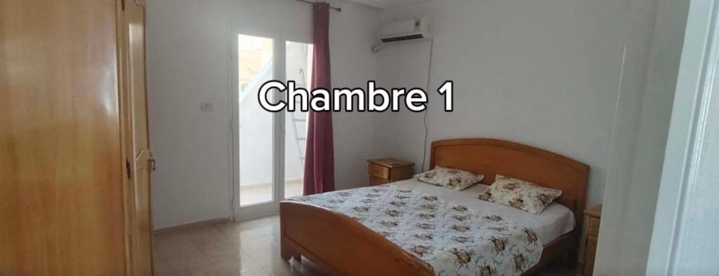 a bedroom with a bed in a room with a window at Dar Tantana sayafi in Hammam Sousse