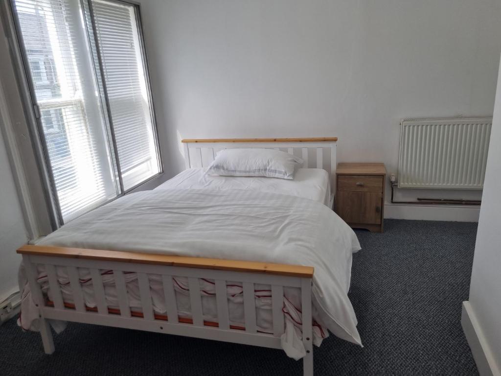 a bed in a room with a large window at City view place, City Centre in Chesterton