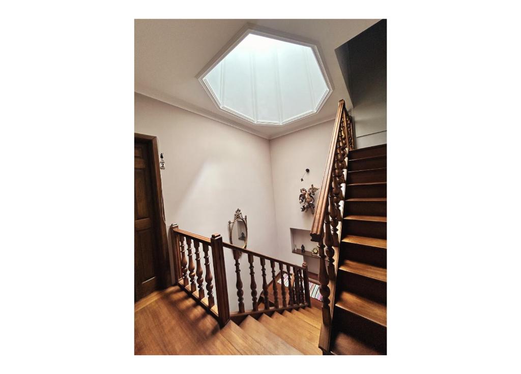 a skylight in the ceiling of a house with stairs at Casa Quixote, Centro Catedral in Braga