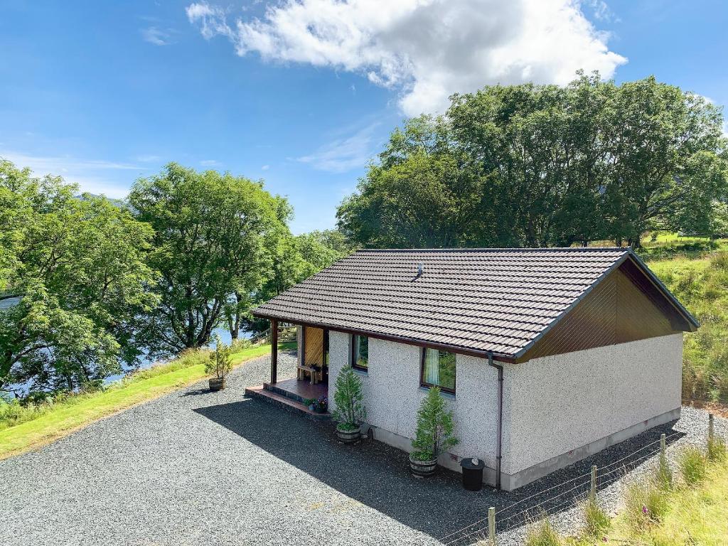 a small house with two plants in front of it at The Narrows in Poolewe