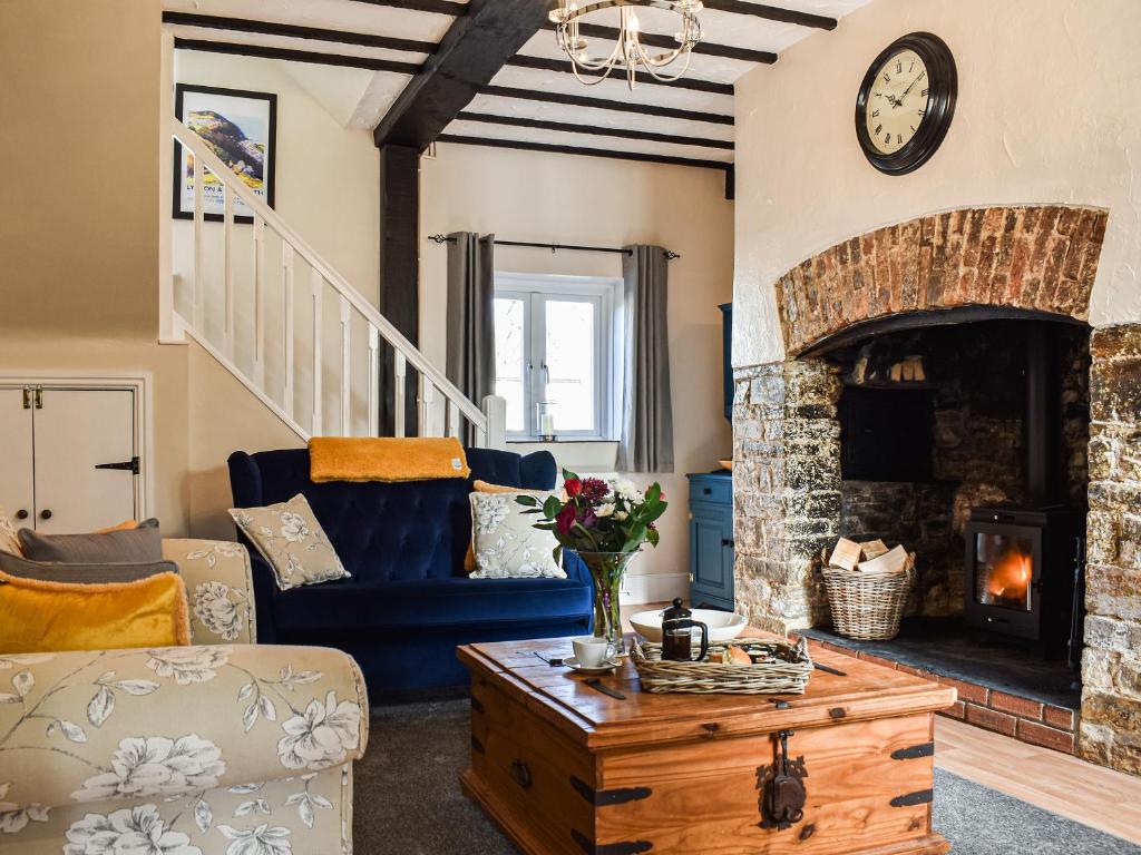 a living room with a couch and a fireplace at The Cottage - Uk35177 in Abbots Bickington