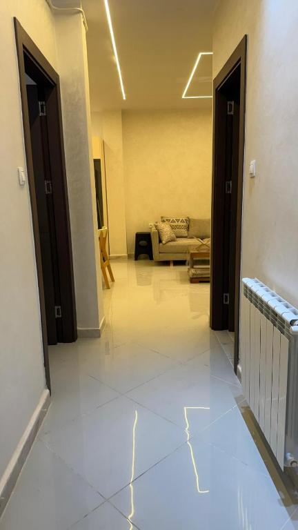 a living room with two doors and a couch at إقامة الرمال الذهبية in Les Hamiane
